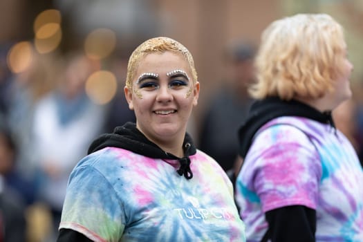 Holland, Michigan, USA - May 11, 2019: Tulip Time Parade, Young women wearing colorful outfits promoting the Tulip Coty Beauty College