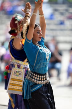 Columbus, Ohio, USA - May 26, 2019: Columbus Asian Festival, Franklin Park, Indian women in traditional clothing, performing traditional Indian dance.