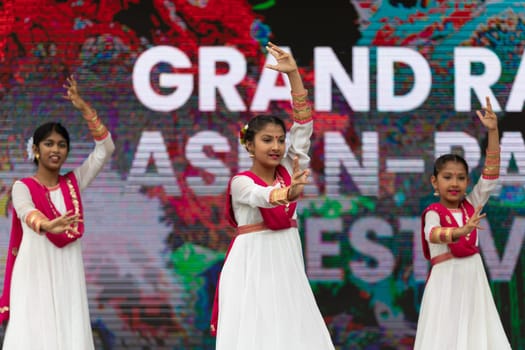 Grand Rapids, Michigan, USA - June 15, 2019: Asian Pacific Festival, Indian dancers wearing traditional clothing, performing a display of traditional dance at the Rosa Parks Circle