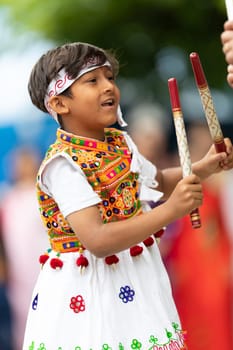 Grand Rapids, Michigan, USA - June 15, 2019: Asian Pacific Festival, indian boy wearing traditional clothing at a fashion display  in the Rosa Parks Circle