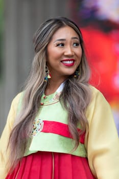 Grand Rapids, Michigan, USA - June 15, 2019: Asian Pacific Festival, korean woman wearing traditional clothing at a fashion display  in the Rosa Parks Circle