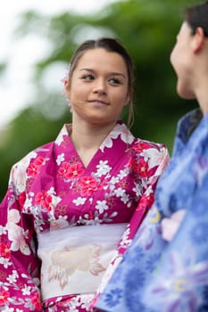 Grand Rapids, Michigan, USA - June 15, 2019: Asian Pacific Festival, japanese woman wearing traditional clothing at a fashion display  in the Rosa Parks Circle
