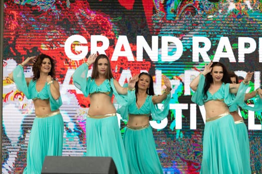 Grand Rapids, Michigan, USA - June 15, 2019: Asian Pacific Festival, Women wearing traditional Egyptian clothing performing traditional dance at the Rosa Parks Circle