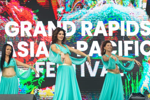 Grand Rapids, Michigan, USA - June 15, 2019: Asian Pacific Festival, Women wearing traditional Egyptian clothing performing traditional dance at the Rosa Parks Circle