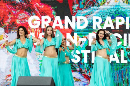 Grand Rapids, Michigan, USA - June 15, 2019: Asian Pacific Festival, Women wearing traditional Egyptian clothing performing traditional dance at the Rosa Parks Circle