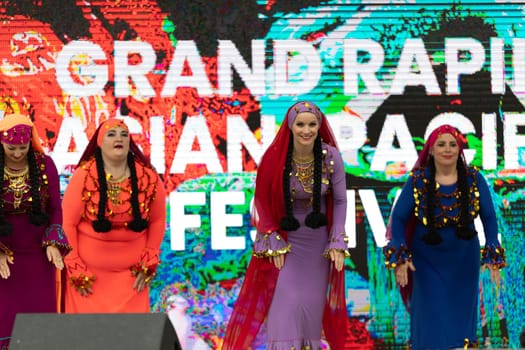 Grand Rapids, Michigan, USA - June 15, 2019: Asian Pacific Festival, Women wearing traditional Egyptian clothing performing traditional dance at the Rosa Parks Circle