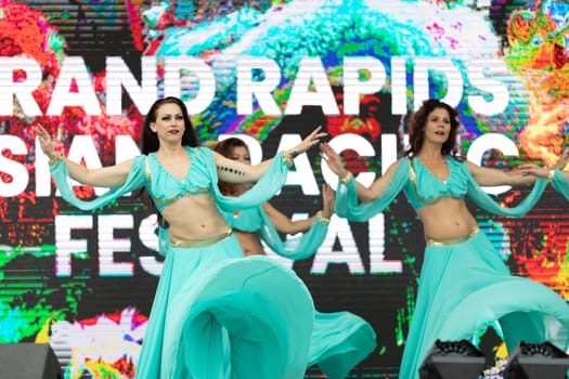 Grand Rapids, Michigan, USA - June 15, 2019: Asian Pacific Festival, Women wearing traditional Egyptian clothing performing traditional dance at the Rosa Parks Circle
