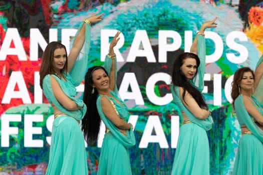 Grand Rapids, Michigan, USA - June 15, 2019: Asian Pacific Festival, Women wearing traditional Egyptian clothing performing traditional dance at the Rosa Parks Circle