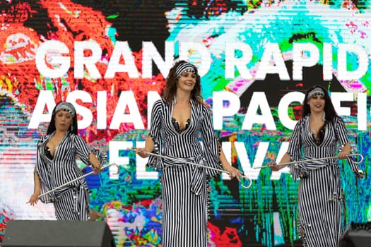 Grand Rapids, Michigan, USA - June 15, 2019: Asian Pacific Festival, Women wearing traditional Egyptian clothing performing traditional dance at the Rosa Parks Circle