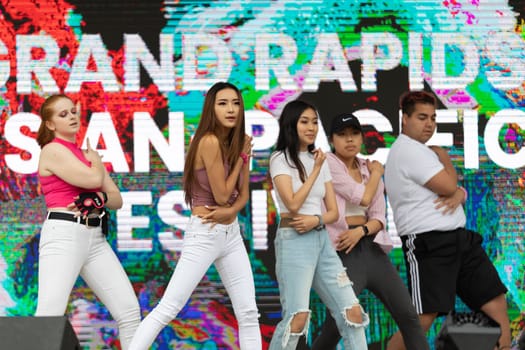 Grand Rapids, Michigan, USA - June 15, 2019: Young Men and Women, performing modern K-POP dance during the asian festival at Rosa Park