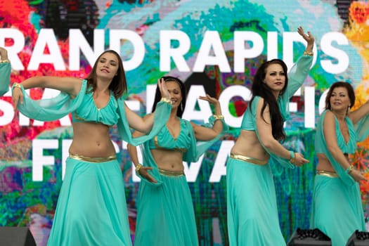 Grand Rapids, Michigan, USA - June 15, 2019: Asian Pacific Festival, Women wearing traditional Egyptian clothing performing traditional dance at the Rosa Parks Circle