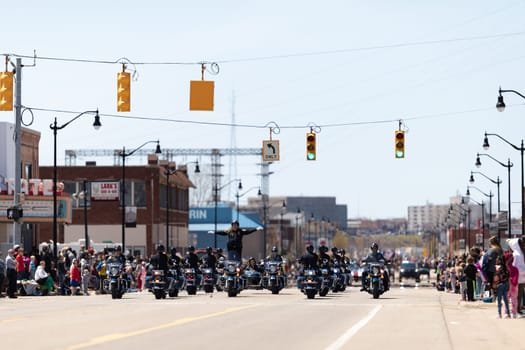 Benton Harbor, Michigan, USA - May 4, 2019: Blossomtime Festival Grand Floral Parade, Indianapolis police motorcycle drill team performing at the parade