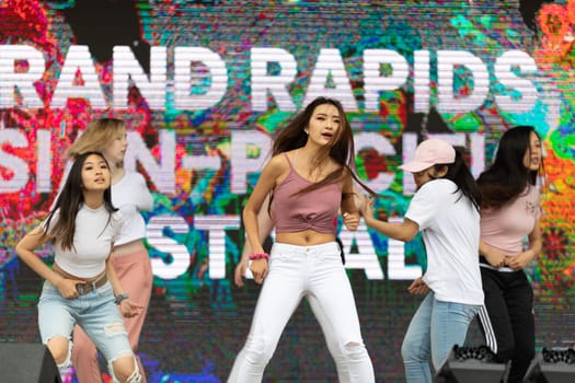 Grand Rapids, Michigan, USA - June 15, 2019: Young Men and Women, performing modern K-POP dance during the asian festival at Rosa Park