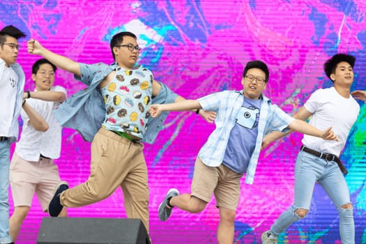 Grand Rapids, Michigan, USA - June 15, 2019: Young Men and Women, performing modern K-POP dance during the asian festival at Rosa Park
