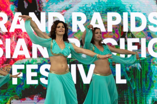 Grand Rapids, Michigan, USA - June 15, 2019: Asian Pacific Festival, Women wearing traditional Egyptian clothing performing traditional dance at the Rosa Parks Circle