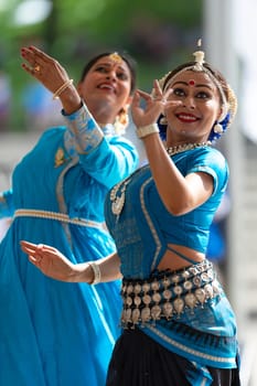 Columbus, Ohio, USA - May 26, 2019: Columbus Asian Festival, Franklin Park, Indian women in traditional clothing, performing traditional Indian dance.