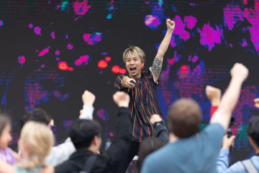 Grand Rapids, Michigan, USA - June 15, 2019: Asian Pacific Festival, Man performing a Japanese style idol dance, with the espectators joining in the dance at the Rosa Parks Circle