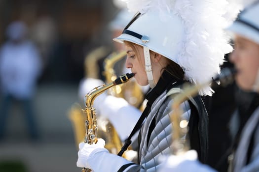 Benton Harbor, Michigan, USA - May 4, 2019: Blossomtime Festival Grand Floral Parade, Members of the Lakeshore Lancer High School Marching Band performing at the parade