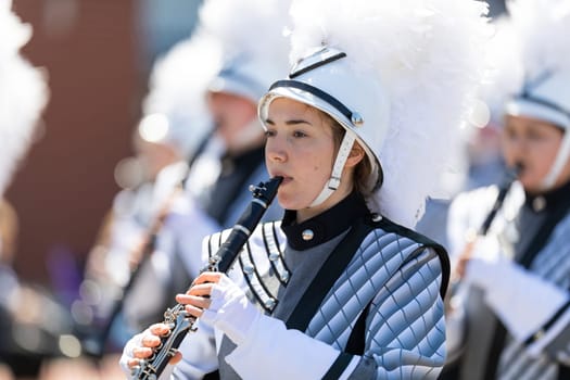 Benton Harbor, Michigan, USA - May 4, 2019: Blossomtime Festival Grand Floral Parade, Members of the Lakeshore Lancer High School Marching Band performing at the parade