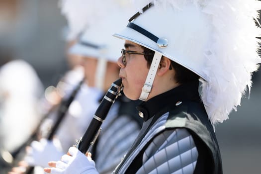 Benton Harbor, Michigan, USA - May 4, 2019: Blossomtime Festival Grand Floral Parade, Members of the Lakeshore Lancer High School Marching Band performing at the parade