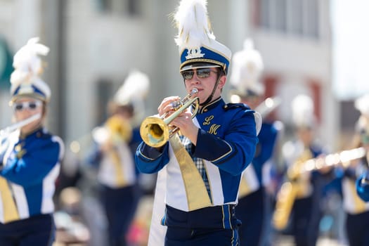 Benton Harbor, Michigan, USA - May 4, 2019: Blossomtime Festival Grand Floral Parade, Members of the Michigan Catholic Lakers Marching Band, performing at the parade
