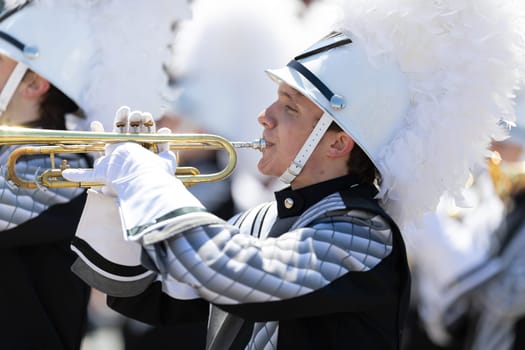 Benton Harbor, Michigan, USA - May 4, 2019: Blossomtime Festival Grand Floral Parade, Members of the Lakeshore Lancer High School Marching Band performing at the parade