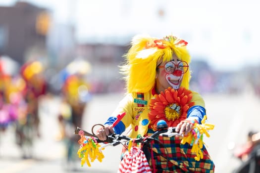Benton Harbor, Michigan, USA - May 4, 2019: Blossomtime Festival Grand Floral Parade, Michiana Clowns riding bicycles during the parade