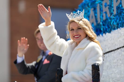 Benton Harbor, Michigan, USA - May 4, 2019: Blossomtime Festival Grand Floral Parade, float carrying Miss South Heaven and her court during the parade