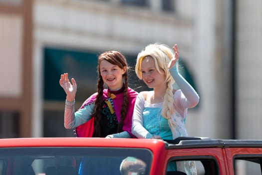 Benton Harbor, Michigan, USA - May 4, 2019: Blossomtime Festival Grand Floral Parade, Girls dress up as frozen characters Anna and Elsa