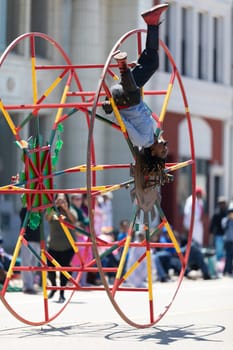 Benton Harbor, Michigan, USA - May 4, 2019: Blossomtime Festival Grand Floral Parade, Sam the wheeler riding a giant wheel at the parade