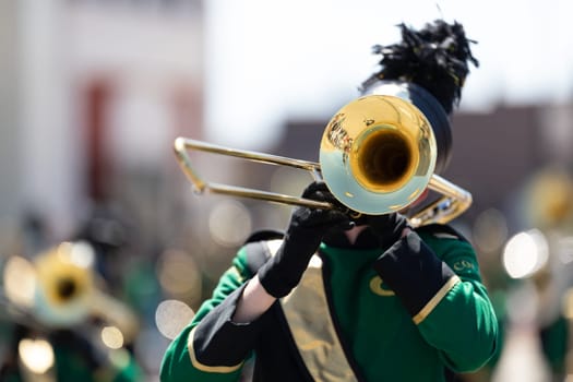 Benton Harbor, Michigan, USA - May 4, 2019: Blossomtime Festival Grand Floral Parade, Members of the Coloma High School Marching Band  performing at the parade