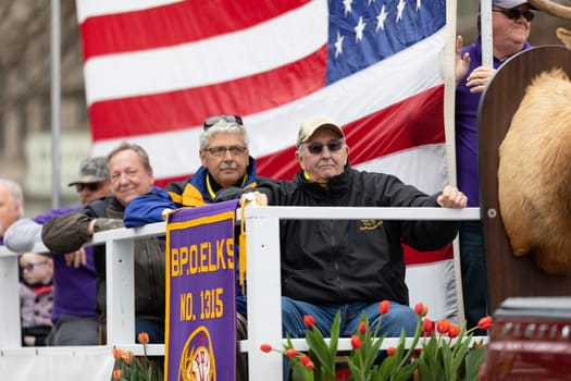 Holland, Michigan, USA - May 11, 2019: Tulip Time Parade, Float transporting United States Military Veterans  down the road during the parade