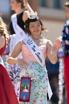 Benton Harbor, Michigan, USA - May 4, 2019: Blossomtime Festival Grand Floral Parade, Float carrying Miss Coloma and her court during the parade