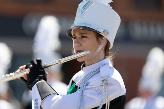 Benton Harbor, Michigan, USA - May 4, 2019: Blossomtime Festival Grand Floral Parade, Hartford High School Emerald Vanguard marching band, performing at the parade