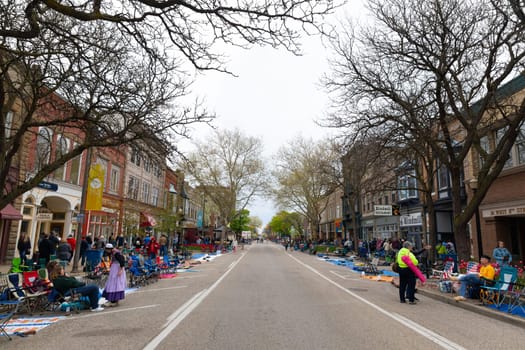 Holland, Michigan, USA - May 11, 2019: People along the old buildings at west 8th Street prior to the tulip time festival parade