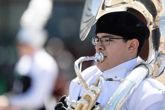 Benton Harbor, Michigan, USA - May 4, 2019: Blossomtime Festival Grand Floral Parade, Hartford High School Emerald Vanguard marching band, performing at the parade