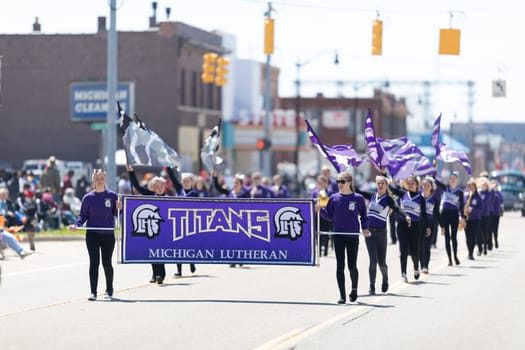 Benton Harbor, Michigan, USA - May 4, 2019: Blossomtime Festival Grand Floral Parade, Members of the Titans Michigan Lutheran Marching band performing at the parade