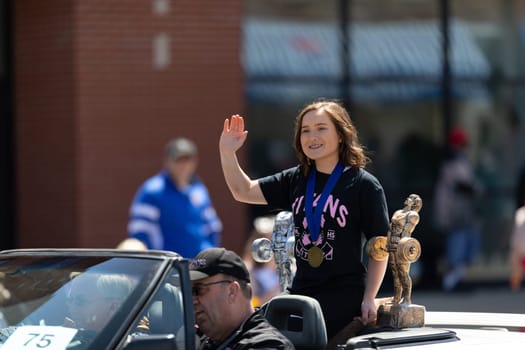 Benton Harbor, Michigan, USA - May 4, 2019: Blossomtime Festival Grand Floral Parade, car transportinf Michigan state Champion Powerlifting during the parade