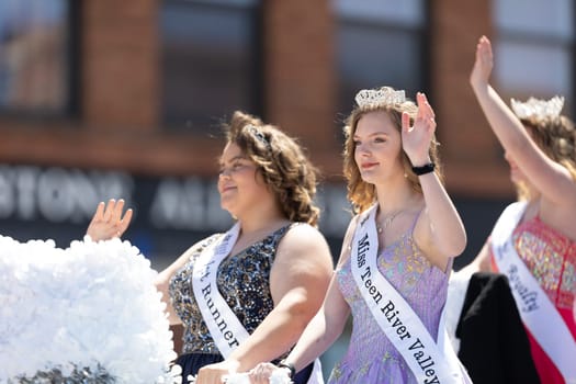 Benton Harbor, Michigan, USA - May 4, 2019: Blossomtime Festival Grand Floral Parade, Float carrying Miss River Valley and her court during the parade
