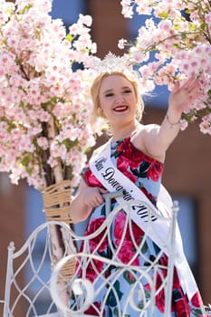 Benton Harbor, Michigan, USA - May 4, 2019: Blossomtime Festival Grand Floral Parade, Float carrying miss Dowagiac and her court at the parade