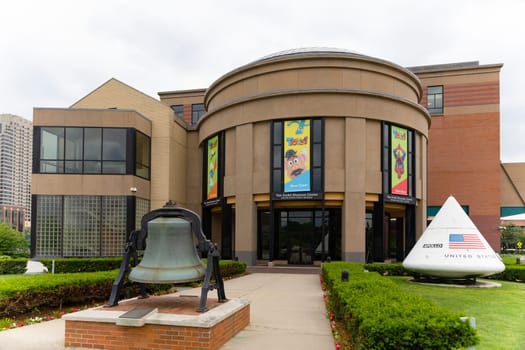 Grand Rapids , Michigan, USA - June 15, 2019: The  Andel Museum Center, Public Museum, with a space capsule and a historic bell at the entrance