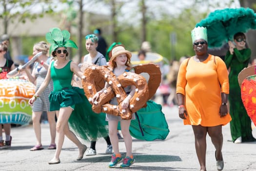 Cleveland, Ohio, USA - June 8, 2019: Parade the Circle, young redhead dress up as a pretzel