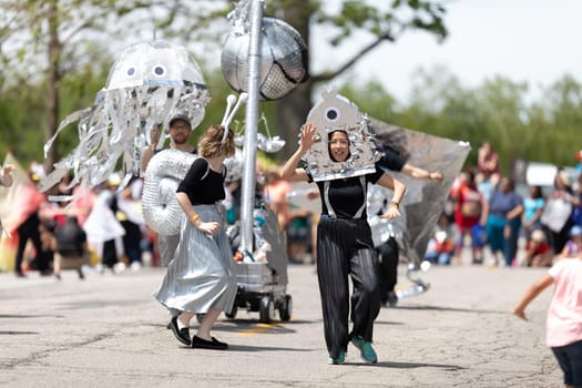 Cleveland, Ohio, USA - June 8, 2019: Parade the Circle, young woman wearing an abstract outfit dancing