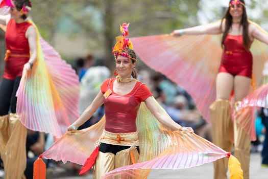 Cleveland, Ohio, USA - June 8, 2019: Parade the Circle, women on stilts with outfits with wings at the parade