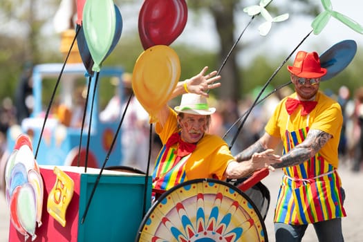 Cleveland, Ohio, USA - June 8, 2019: Parade the Circle, man riding on a wheelchair that looks like a balloon vendor cart
