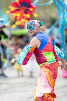 Cleveland, Ohio, USA - June 8, 2019: Parade the Circle, man wearing a colorful outfit and face mask dancing