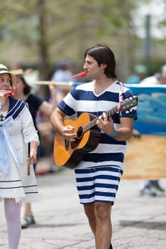 Cleveland, Ohio, USA - June 8, 2019: Parade the Circle, man wearing a sailor outfit playing the guitar
