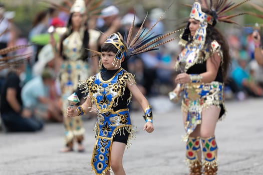 Cleveland, Ohio, USA - June 8, 2019: Parade the Circle, woman and children using aztek outfits dancing.