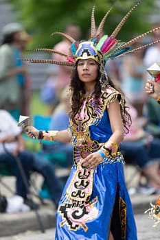 Cleveland, Ohio, USA - June 8, 2019: Parade the Circle, woman and children using aztek outfits dancing.