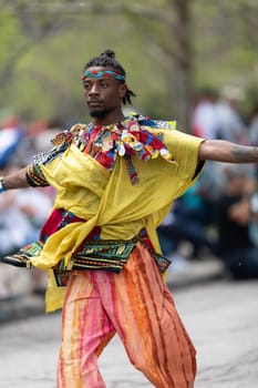 Cleveland, Ohio, USA - June 8, 2019: Parade the Circle, African American man dancing with ribbons during the parade